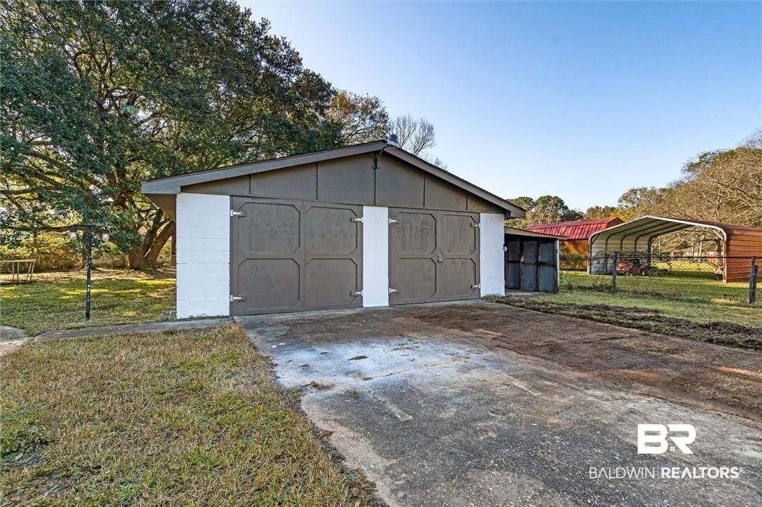 3005 Club House Road Mobile, AL 36605 - Photo 18 of 20 View of outdoor structure with a carport and a lawn