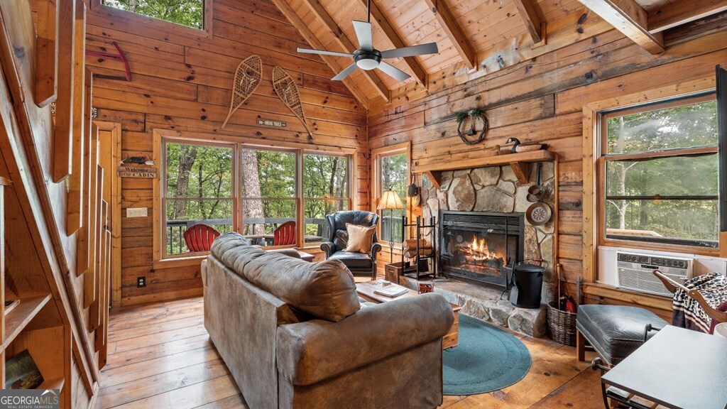 390 Butler Creek Road, Unit 10 Cherry Log, GA 30522 - Photo 12 of 27 a living room with furniture a fireplace and a floor to ceiling window