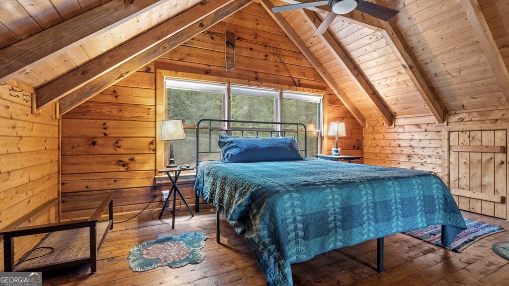 390 Butler Creek Road, Unit 10 Cherry Log, GA 30522 - Photo 15 of 27 a bedroom with a bed a chair and glass door