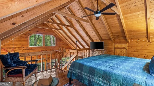 a bedroom with a bed and a chair