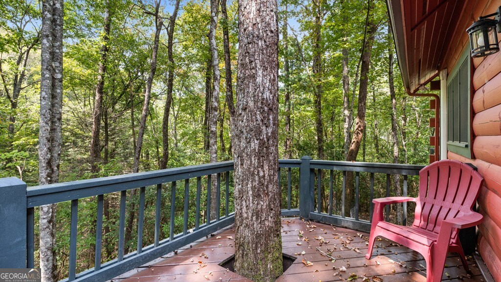390 Butler Creek Road, Unit 10 Cherry Log, GA 30522 - Photo 20 of 27 a view of roof with two chairs and wooden fence