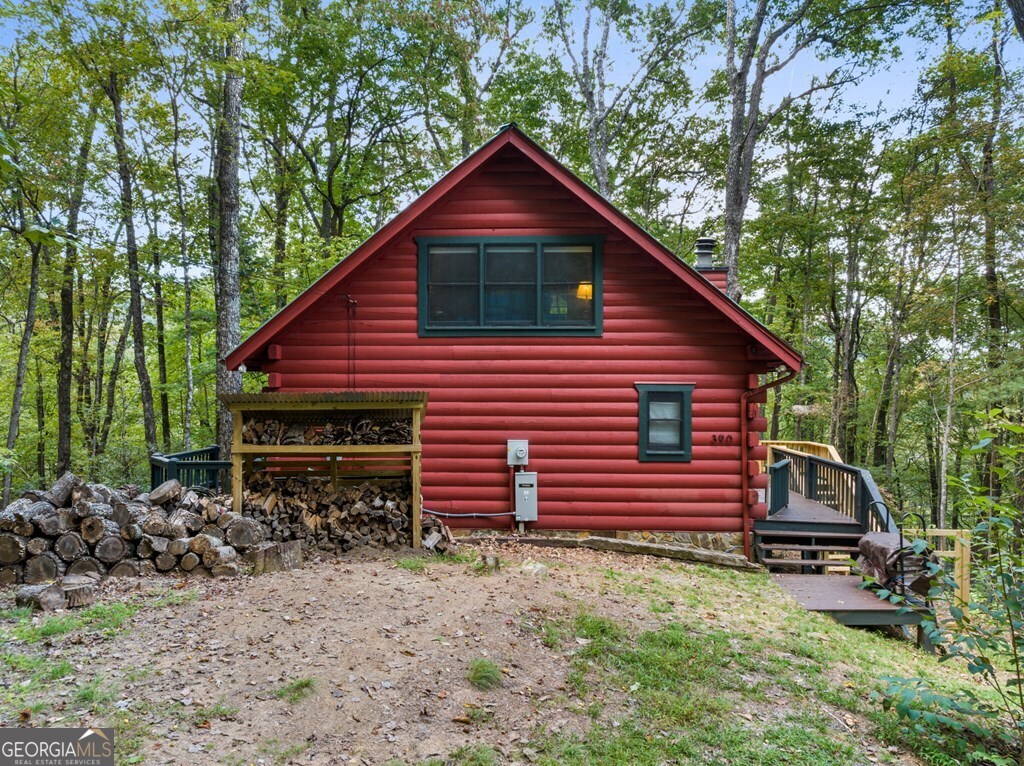 390 Butler Creek Road, Unit 10 Cherry Log, GA 30522 - Photo 23 of 27 a backyard of a house with wooden fence and large trees