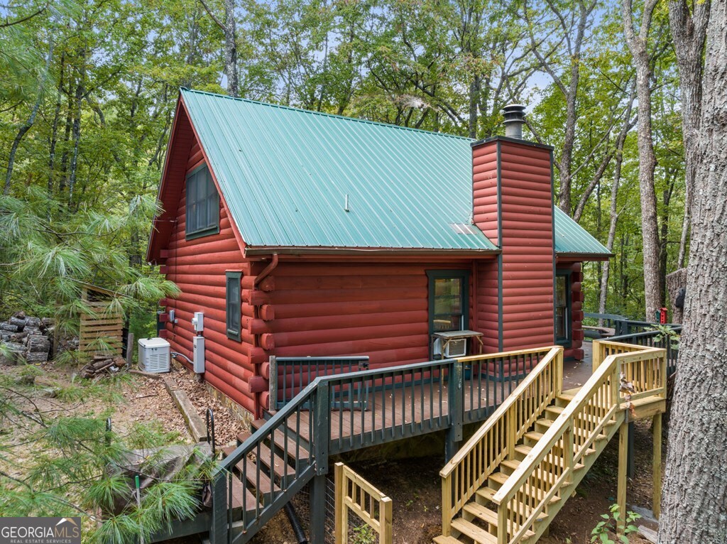 390 Butler Creek Road, Unit 10 Cherry Log, GA 30522 - Photo 25 of 27 a front view of a house with a garden