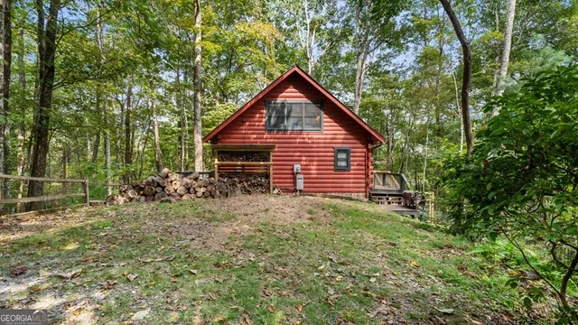 a view of a backyard with barn and wooden fence