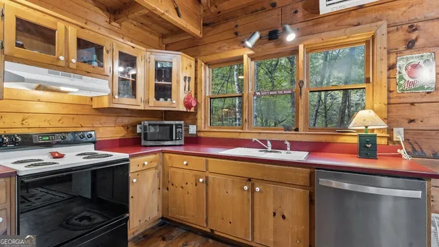 a kitchen with a sink and a stove
