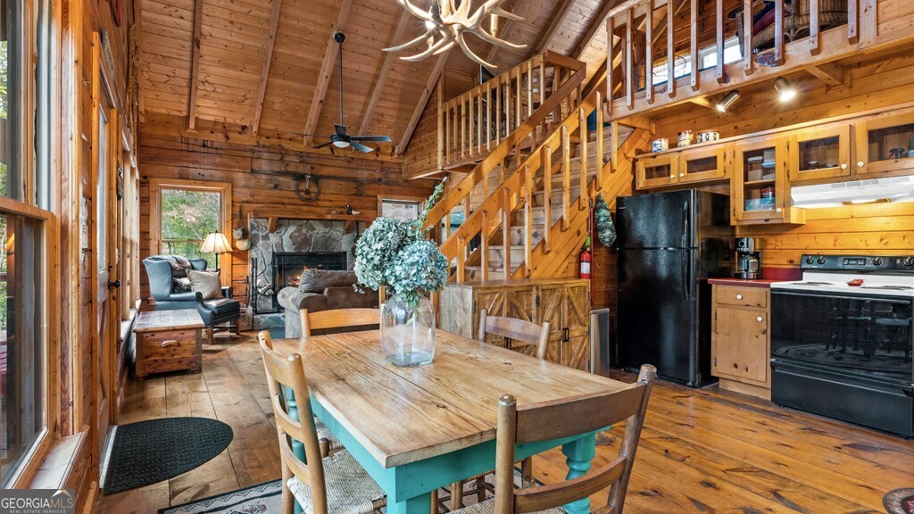 390 Butler Creek Road, Unit 10 Cherry Log, GA 30522 - Photo 6 of 27 a view of a dining room with furniture a chandelier and wooden floor