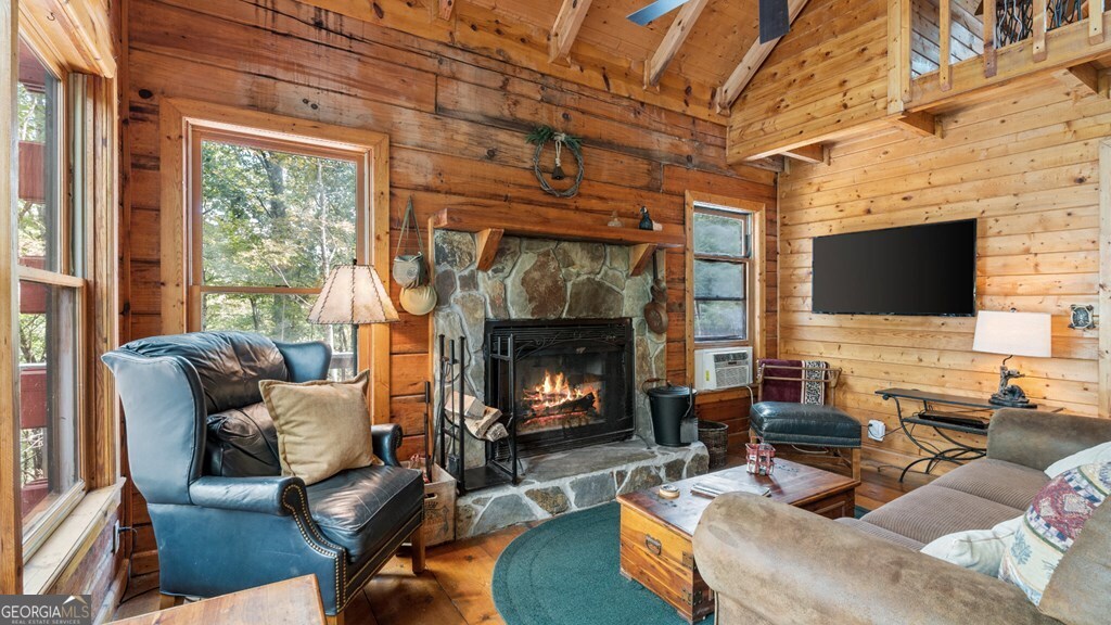 390 Butler Creek Road, Unit 10 Cherry Log, GA 30522 - Photo 7 of 27 a living room with furniture a fireplace and a flat screen tv