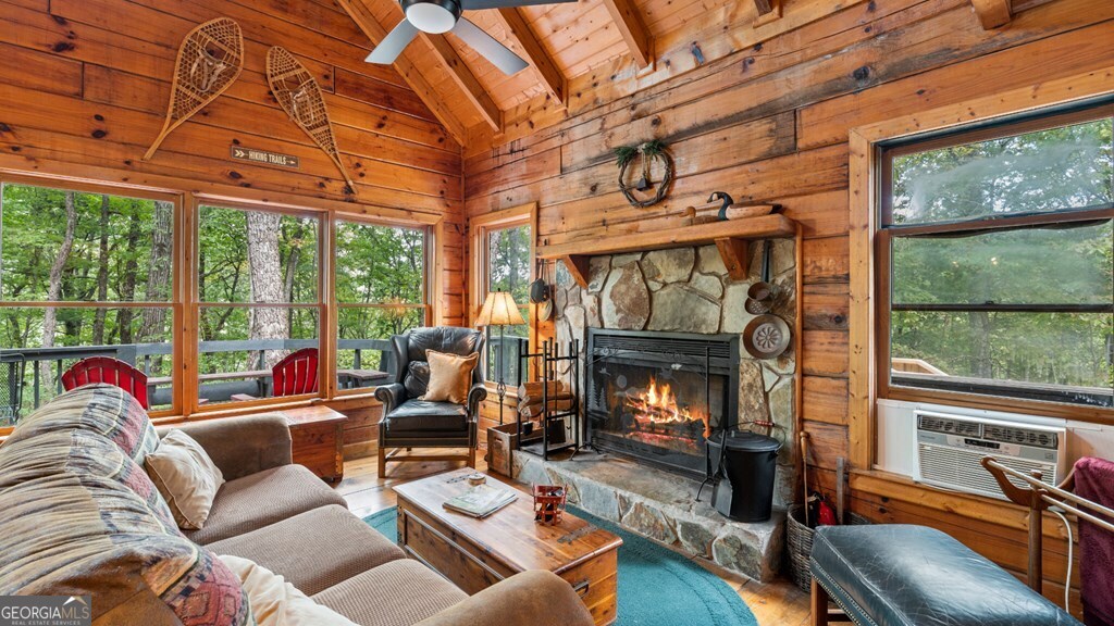390 Butler Creek Road, Unit 10 Cherry Log, GA 30522 - Photo 8 of 27 a living room with furniture a fireplace and floor to ceiling windows