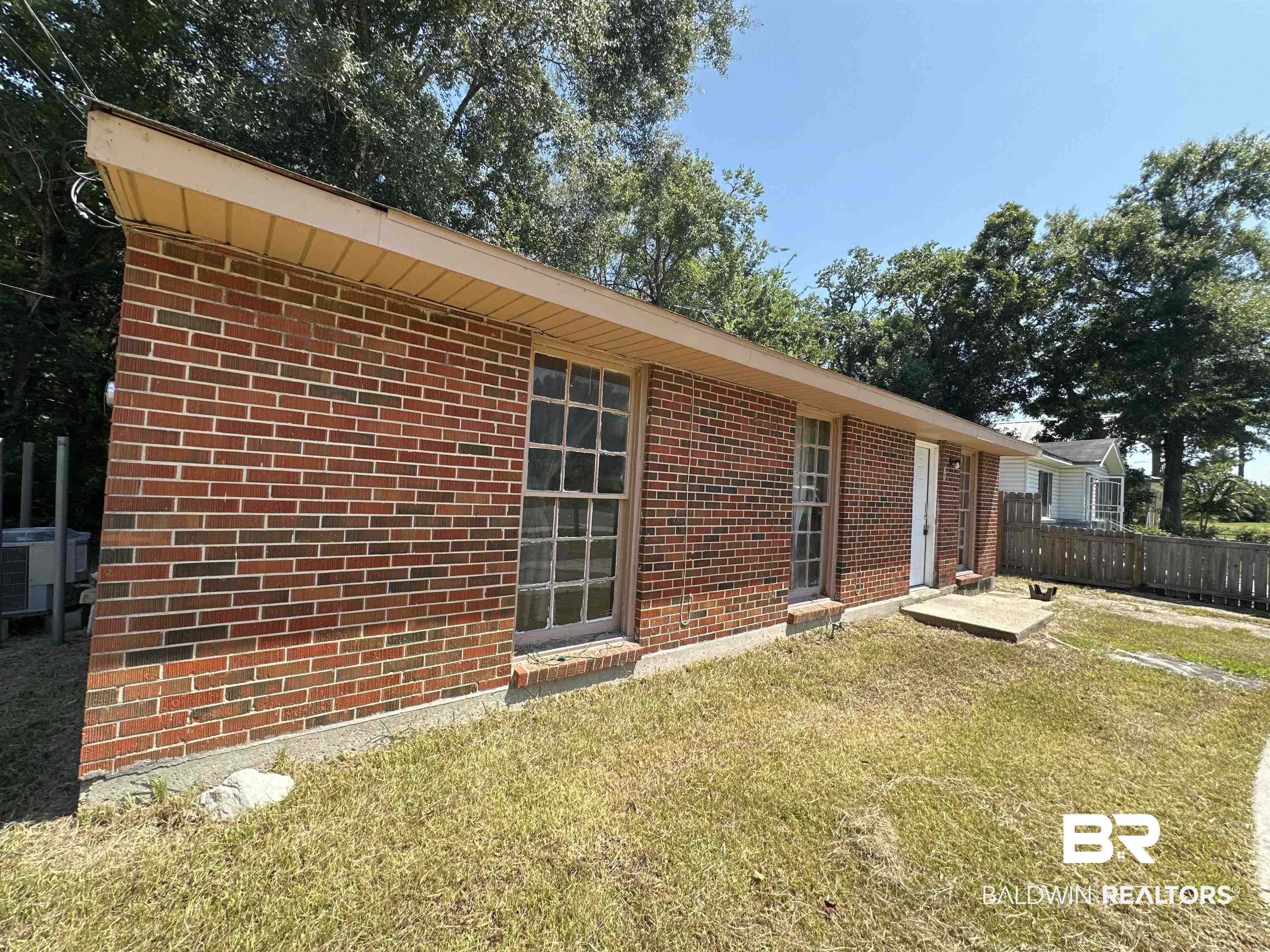 58 Chieftain Way Mobile, AL 36611 - Photo 5 of 12 View of home's exterior featuring cooling unit and a yard