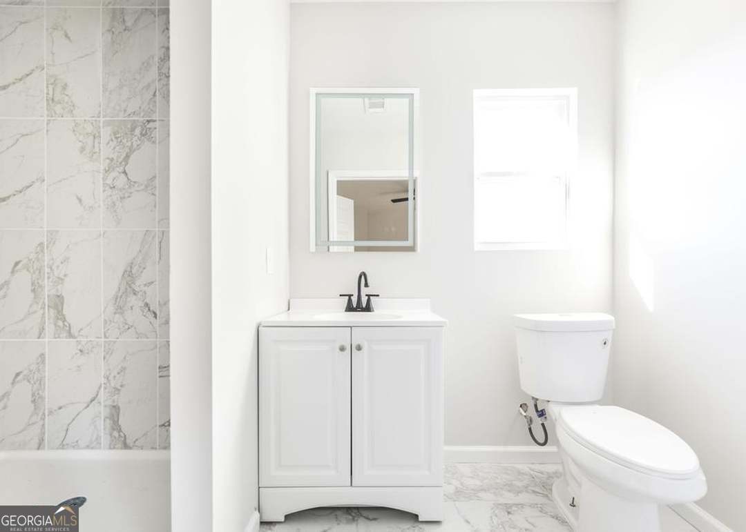 114 Emily Street Macon, GA 31204 - Photo 16 of 24 a white toilet sitting next to a bathroom sink