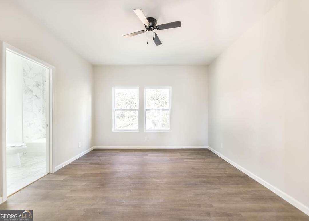 114 Emily Street Macon, GA 31204 - Photo 18 of 24 wooden floor in an empty room with a window