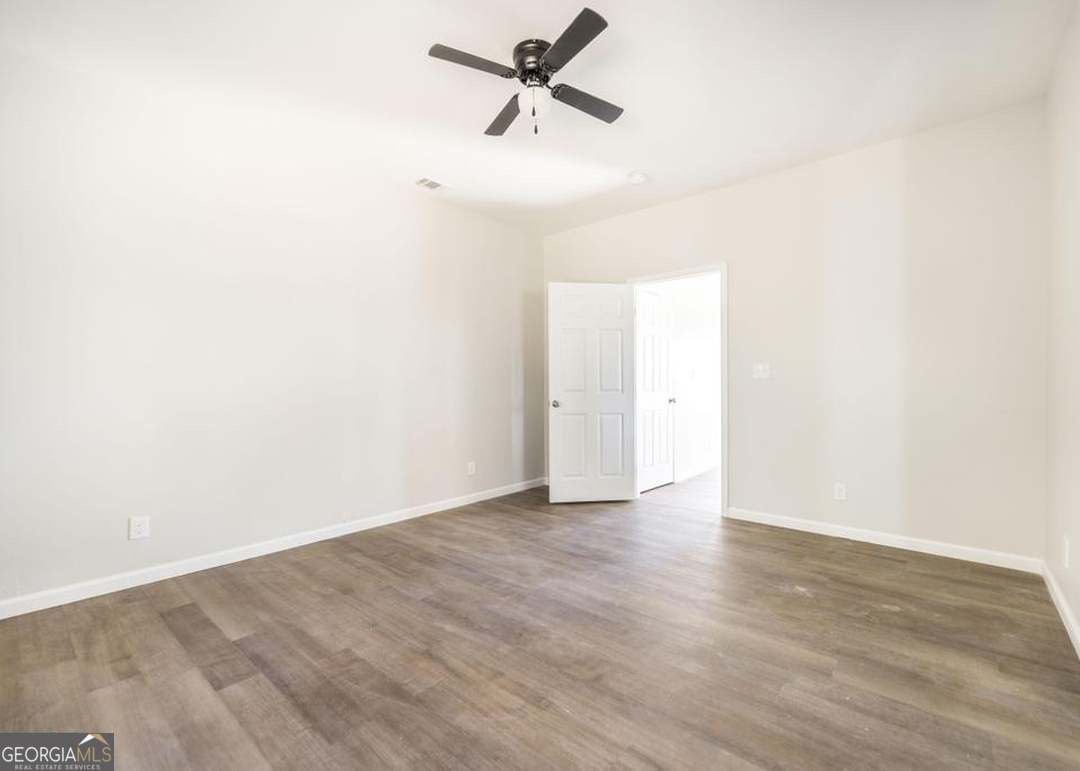 114 Emily Street Macon, GA 31204 - Photo 19 of 24 an empty room with wooden floor and a ceiling fan