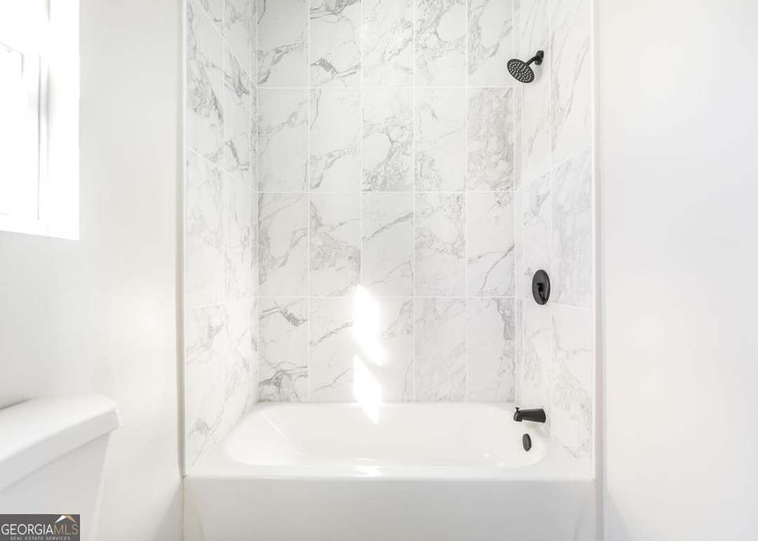 114 Emily Street Macon, GA 31204 - Photo 21 of 24 a bathroom with a bathtub and shower