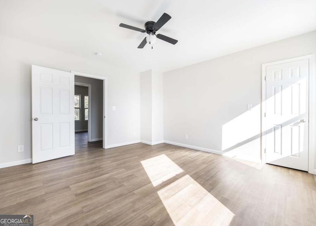 114 Emily Street Macon, GA 31204 - Photo 24 of 24 an empty room with wooden floor fan and windows