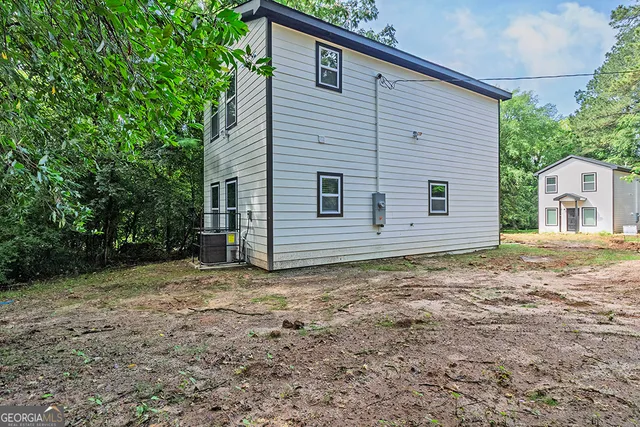 a house with trees in the background