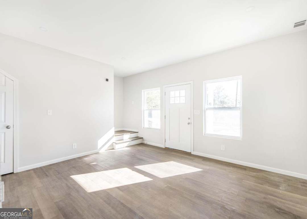 114 Emily Street Macon, GA 31204 - Photo 9 of 24 an empty room with wooden floor and windows