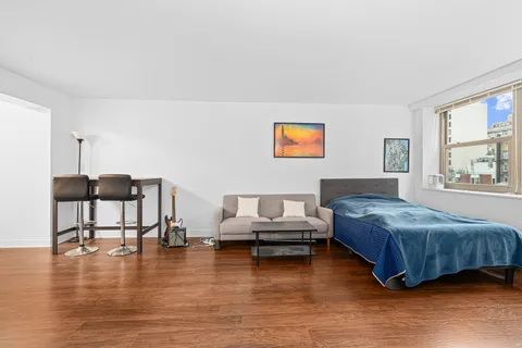 a bedroom with furniture and a wooden floor