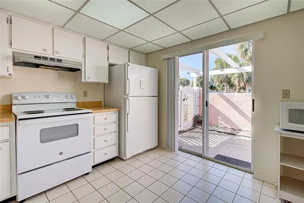 a kitchen with white cabinets and white appliances