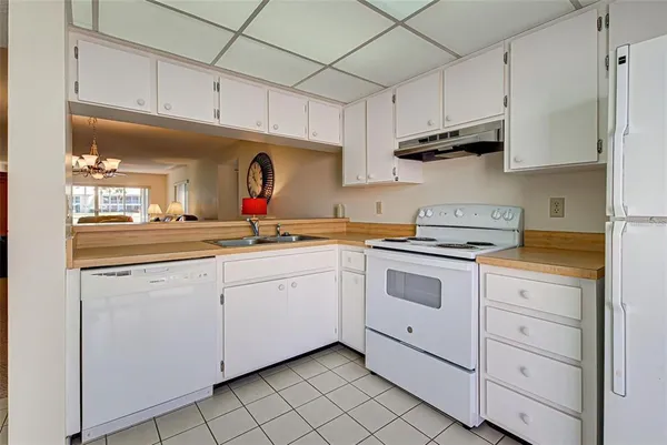 a kitchen with stainless steel appliances granite countertop a sink a stove and cabinets