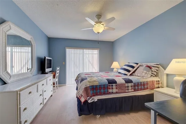 a spacious bedroom with a bed and a chandelier