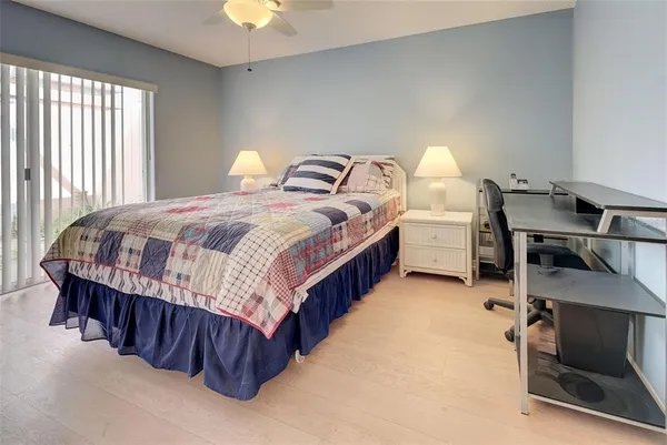 a bedroom with bed and a chandelier