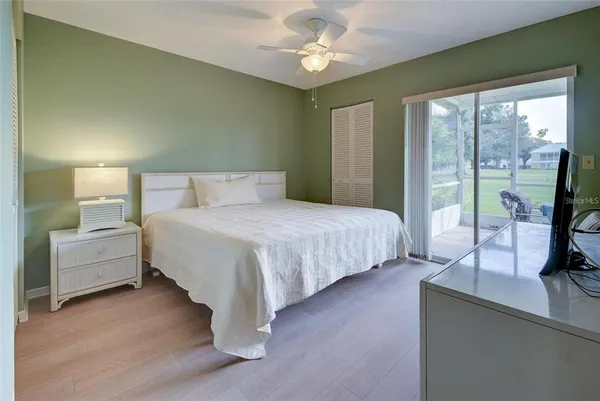 a bedroom with double bed and a large window