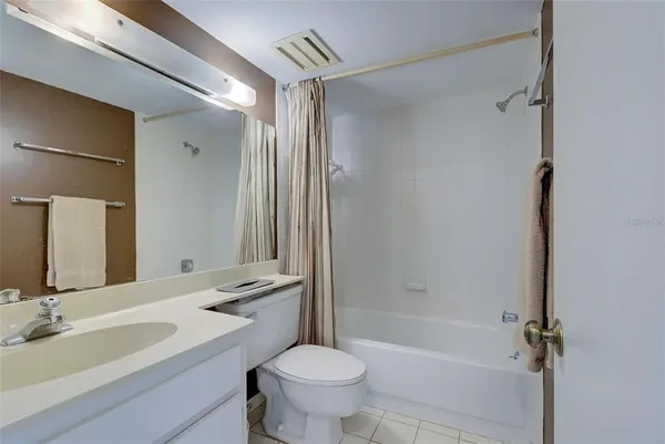 a bathroom with a sink toilet tub and shower
