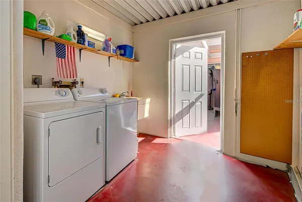 a view of a storage & utility room with a washer dryer