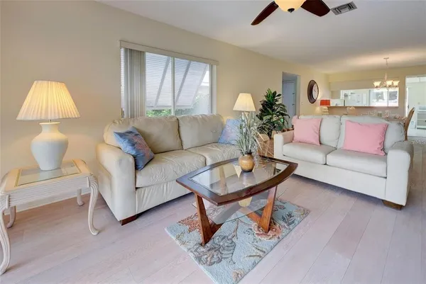 a living room with furniture and a lamp