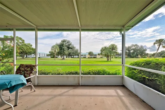 a view of a porch with furniture and garden