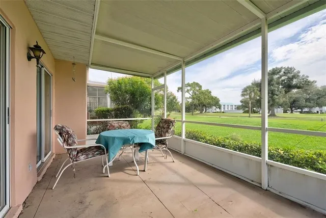 a view of a porch with furniture and garden