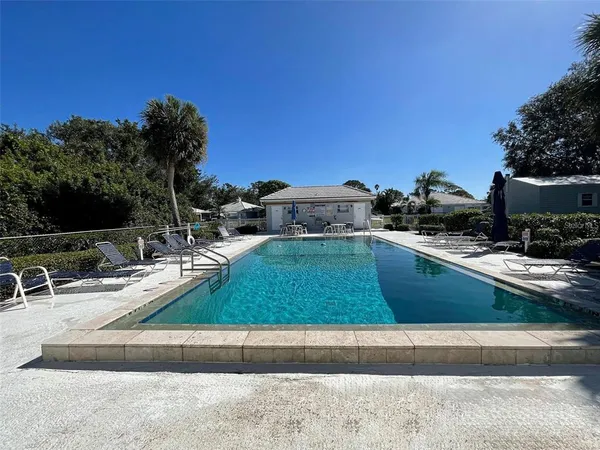 a view of a swimming pool with a lounge chair