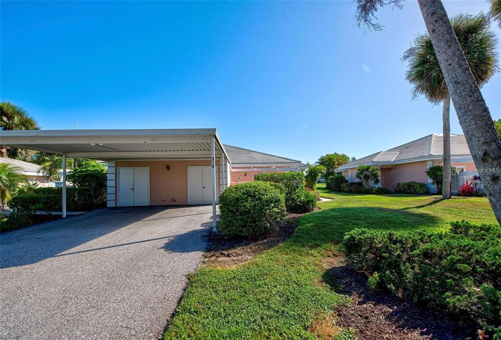 314 Cerromar Way, Unit 16 Venice, FL 34293 - Photo 44 of 47 a front view of a house with a yard and potted plants