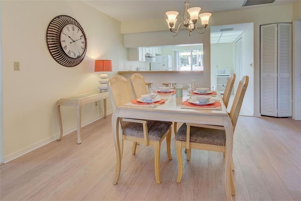 314 Cerromar Way, Unit 16 Venice, FL 34293 - Photo 9 of 47 a view of a dining room with furniture and wooden floor