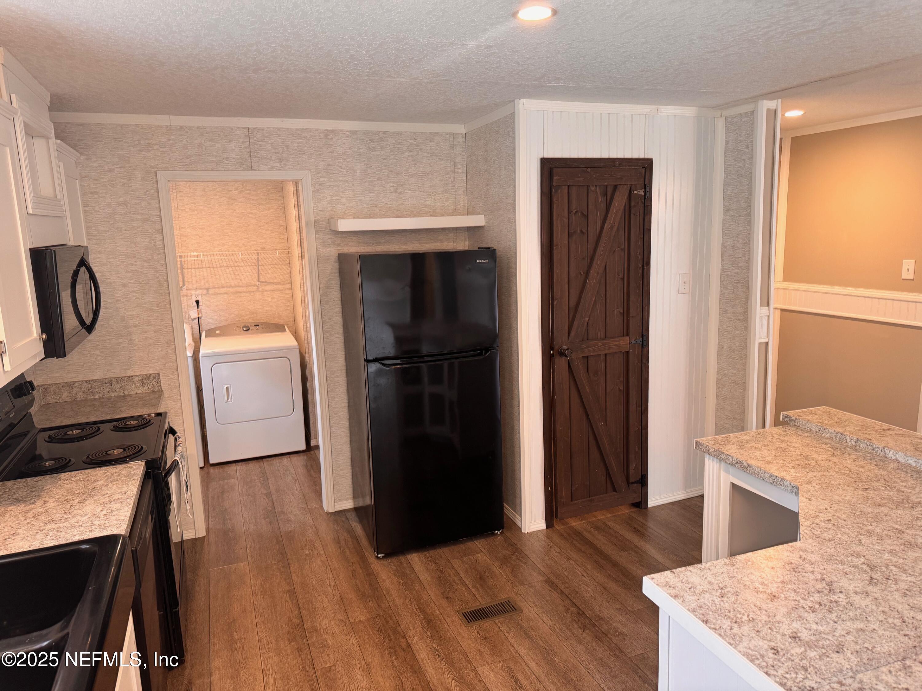95608 Clearwater Road Fernandina Beach, FL 32034 - Photo 14 of 32 a kitchen with a refrigerator and a sink