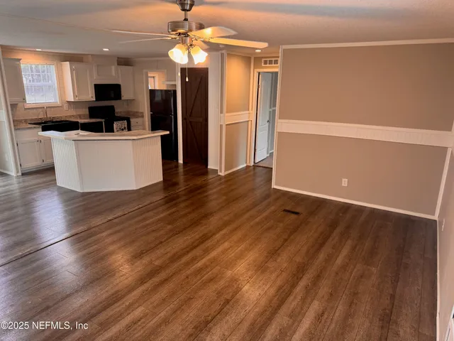 a view of a kitchen with a sink stainless steel appliances and cabinets