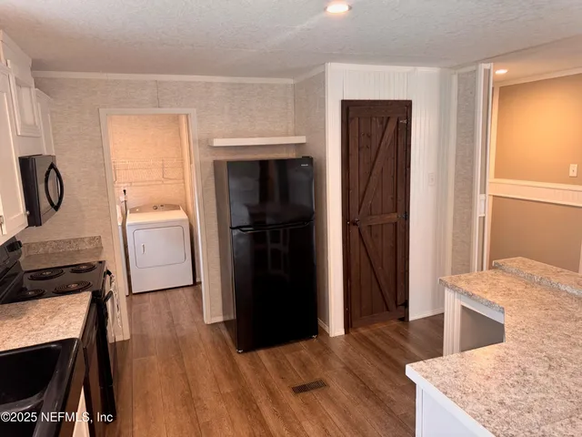 a kitchen with a refrigerator and a sink