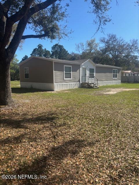 95608 Clearwater Road Fernandina Beach, FL 32034 - Photo 2 of 32 a front view of a house with a yard