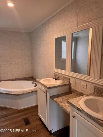 a bathroom with a granite countertop sink and a toilet