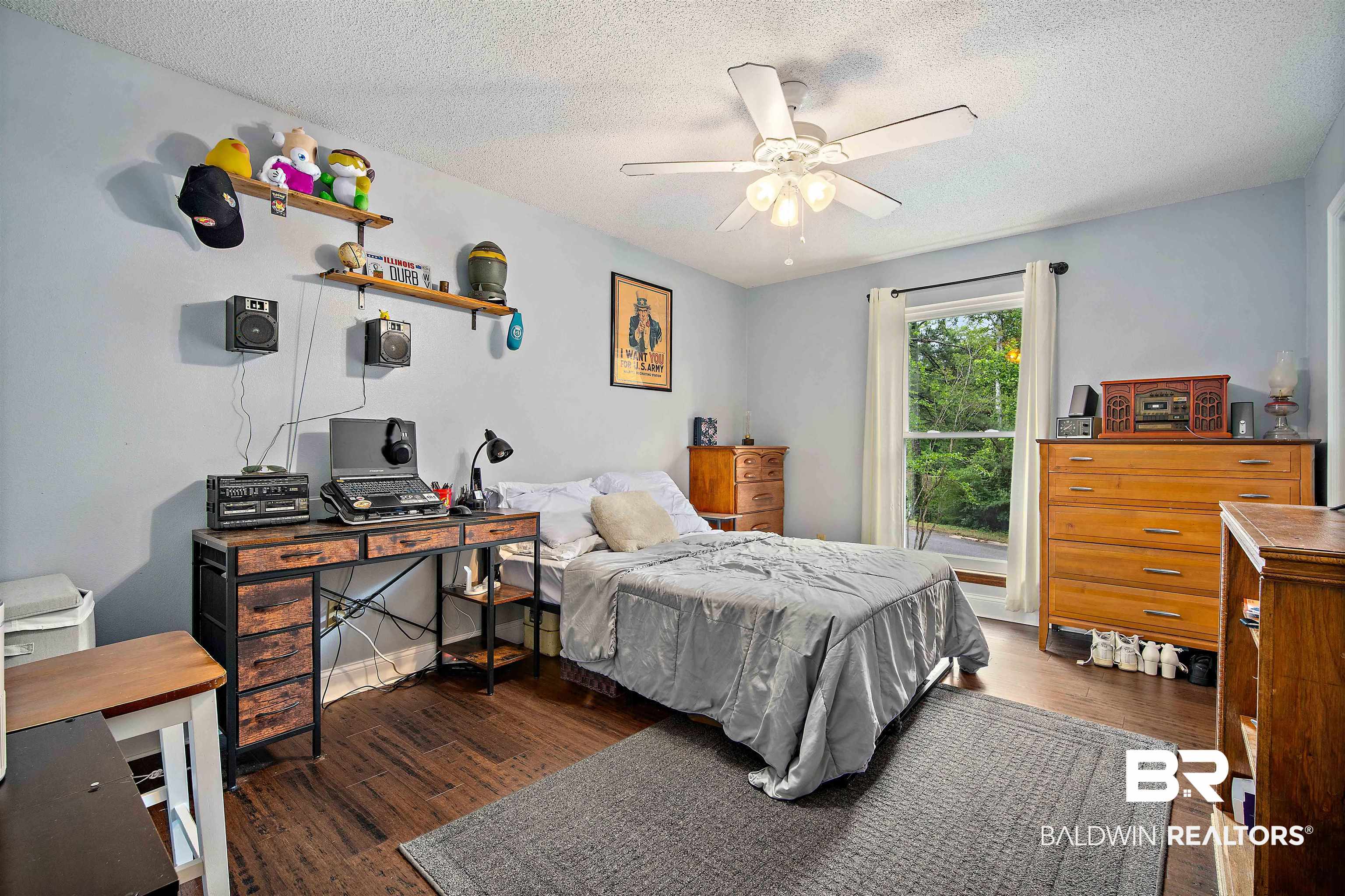 71 Caisson Trace Daphne, AL 36527 - Photo 23 of 36 Bedroom featuring wood-finish flooring, a ceiling fan with light fixture, and a window with white curtains