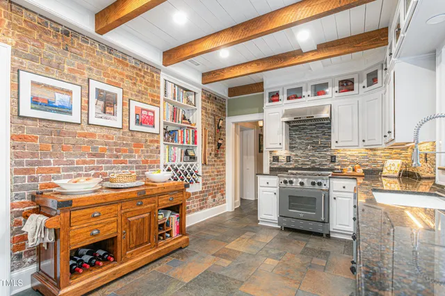 a kitchen with stainless steel appliances granite countertop a stove and a cabinets