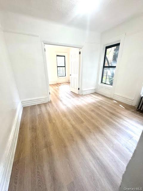 30 Macombs Place, Unit 24 Manhattan, NY 10039 - Photo 3 of 14 a view of an empty room with wooden floor and a window