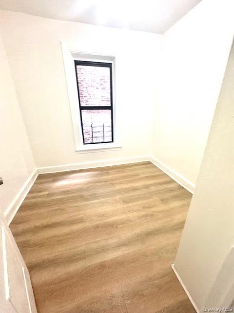 30 Macombs Place, Unit 24 Manhattan, NY 10039 - Photo 7 of 14 a view of an empty room with wooden floor