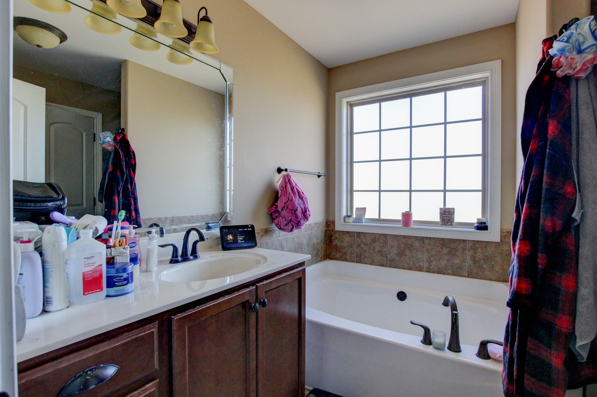 3776 Suiter Road Clarksville, TN 37040 - Photo 13 of 16 a bathroom with a sink vanity tub and a window