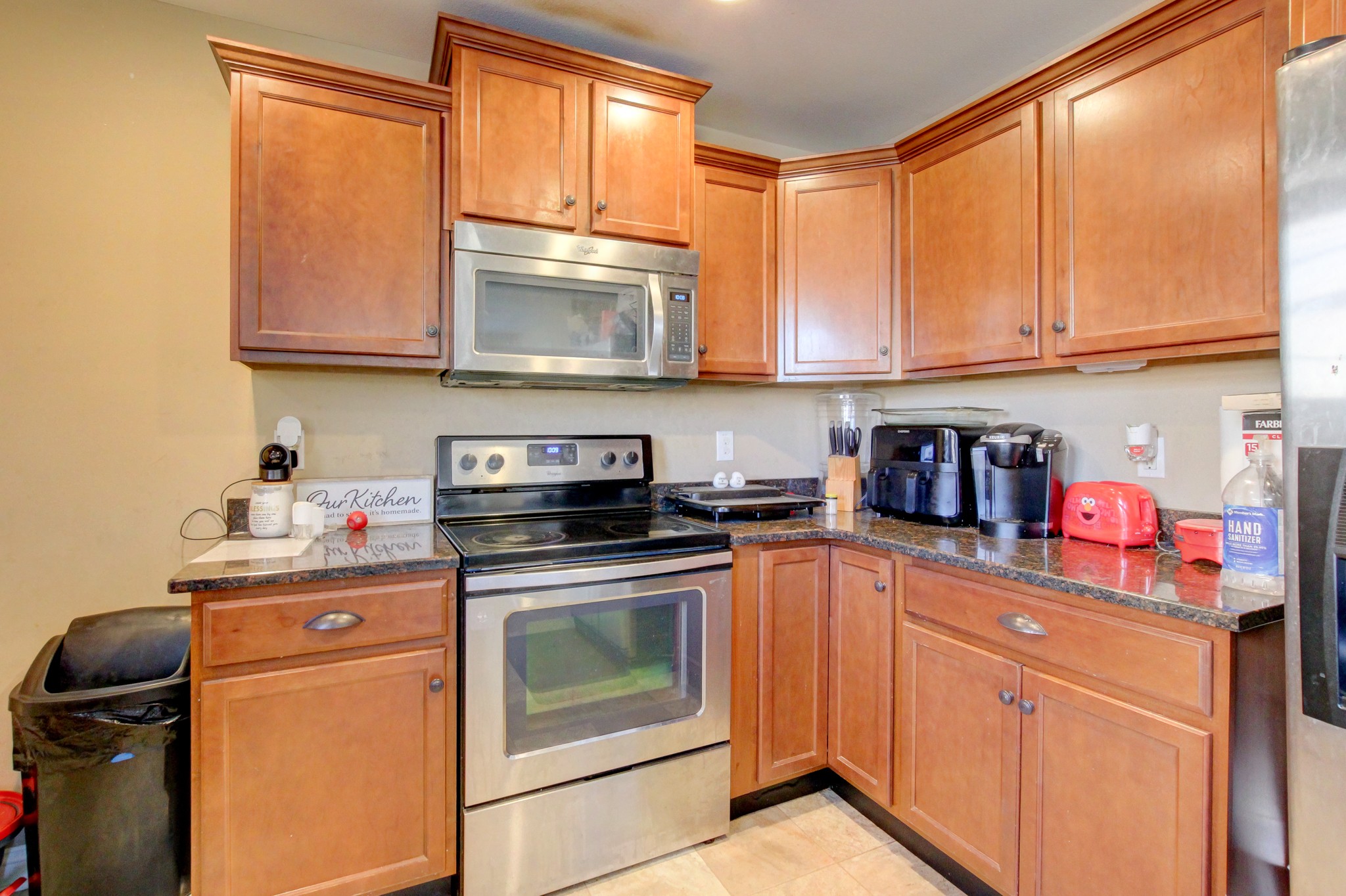 3776 Suiter Road Clarksville, TN 37040 - Photo 6 of 16 a kitchen with stainless steel appliances granite countertop a stove a sink and a microwave