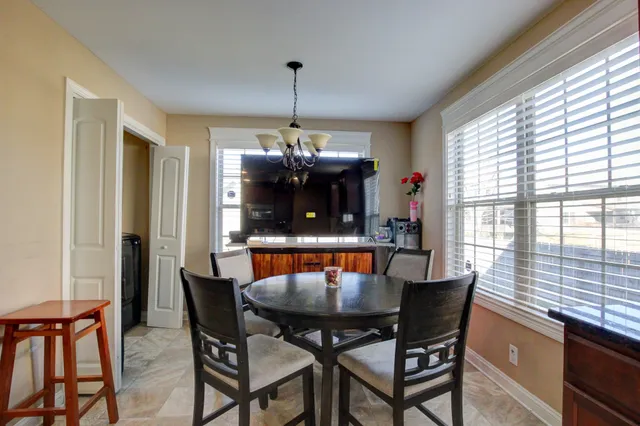 a view of a dining room with furniture window and outside view