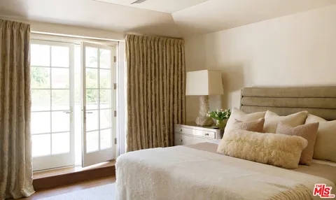 a bedroom with furniture and a window