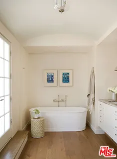 a white bath tub sitting next to a white sink
