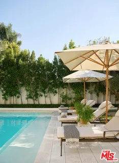 a view of backyard with seating space and trees