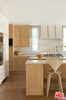 a kitchen with a sink cabinets and window